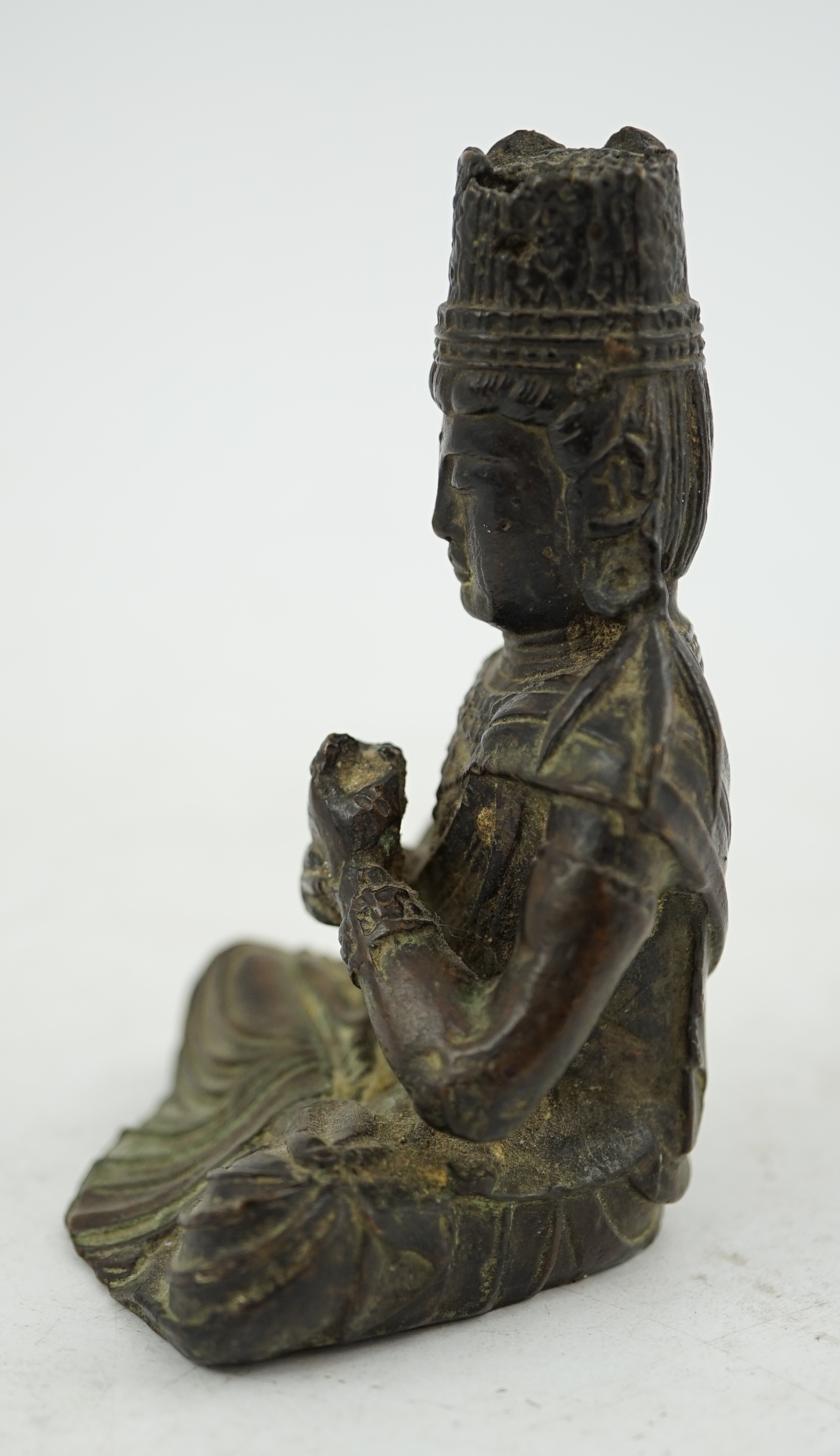 A small South East Asian bronze seated figure of Vairocana Buddha, probably 17th/18th century